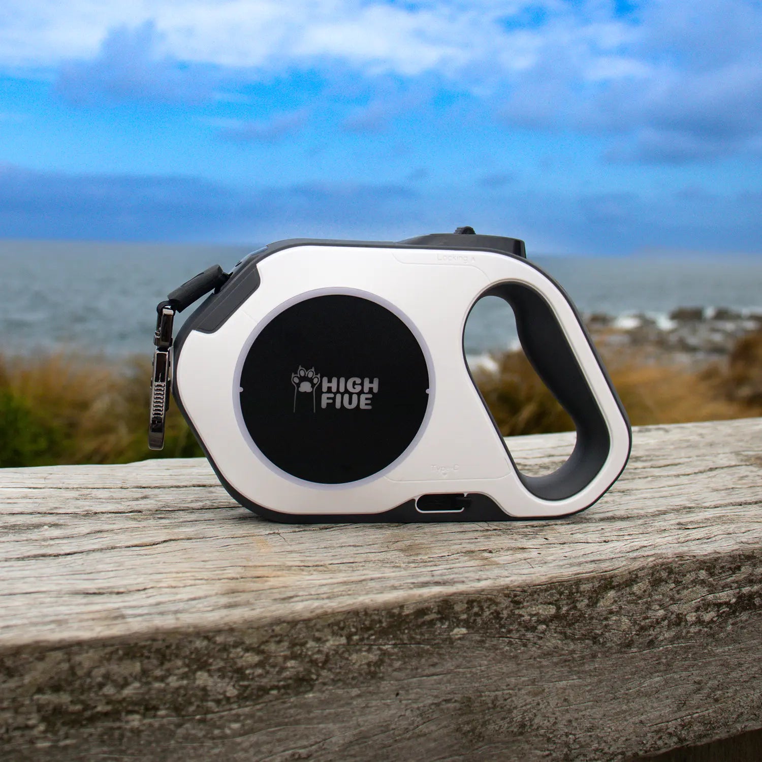 Highfive Retractable dog leash heavy duty large dog extra long dog lead long line white on a wooden surface with a scenic background.